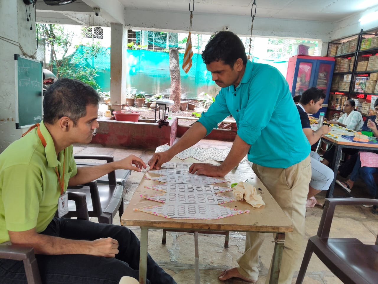 Members working together on craft materials at a table