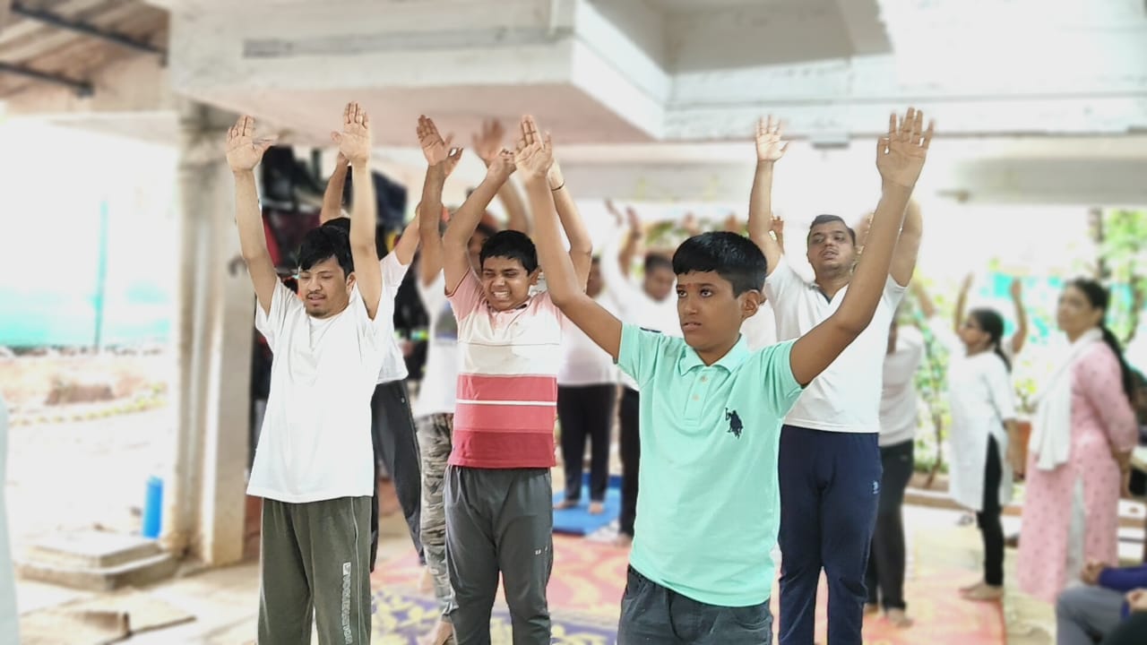 Members doing morning yoga with arms raised