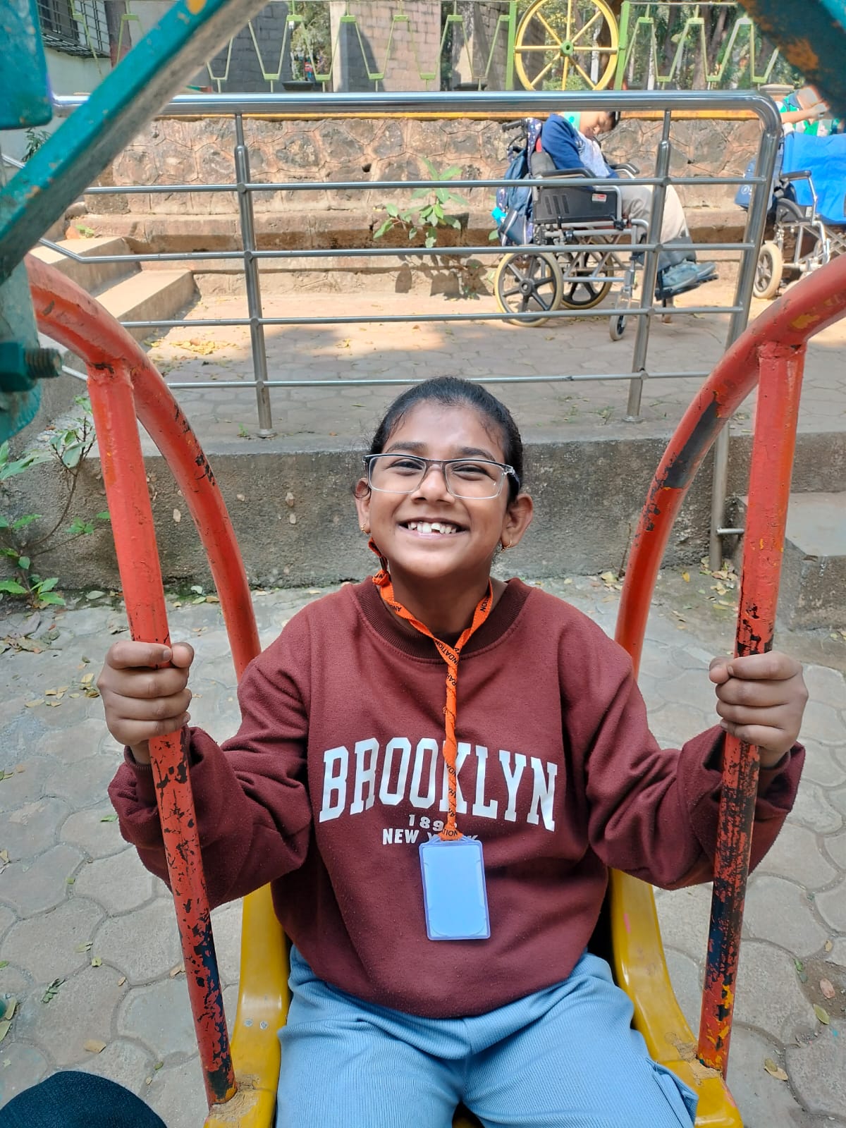 Smiling girl on playground equipment during outdoor activity